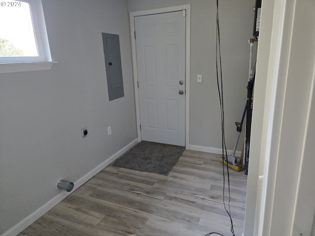 interior space with hookup for an electric dryer, electric panel, and light hardwood / wood-style floors