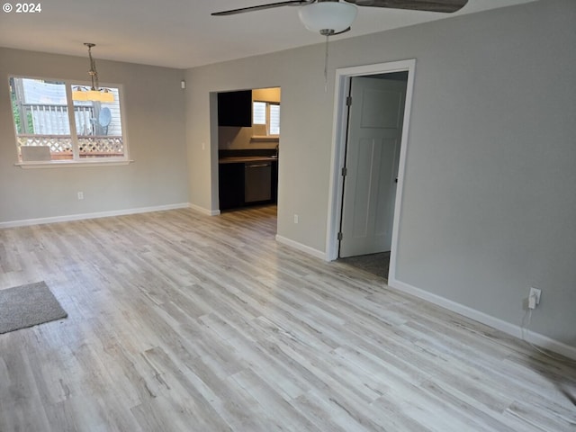 unfurnished living room with light hardwood / wood-style flooring, ceiling fan, and a wealth of natural light