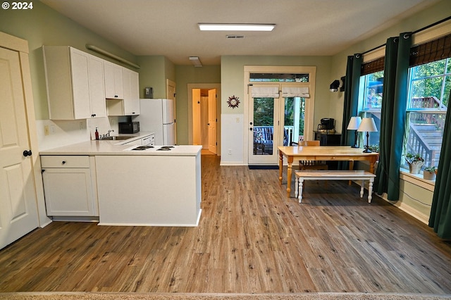 kitchen featuring white cabinetry, french doors, wood-type flooring, and white refrigerator