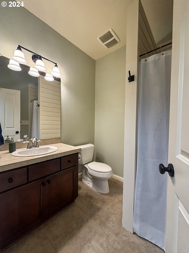 bathroom with tile patterned floors, vanity, and toilet