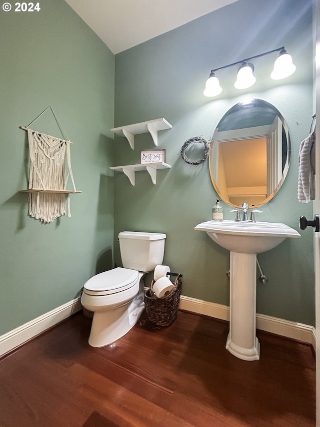 bathroom with hardwood / wood-style flooring and toilet