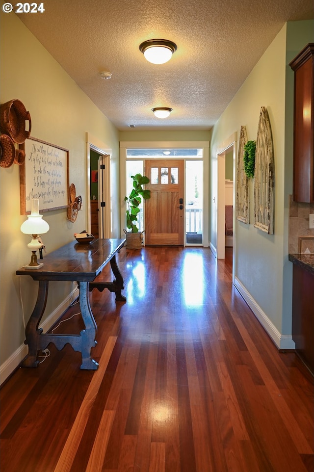 entryway featuring dark hardwood / wood-style floors and a textured ceiling