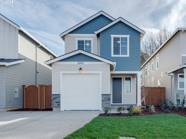 craftsman-style home featuring stone siding, fence, a front lawn, and concrete driveway