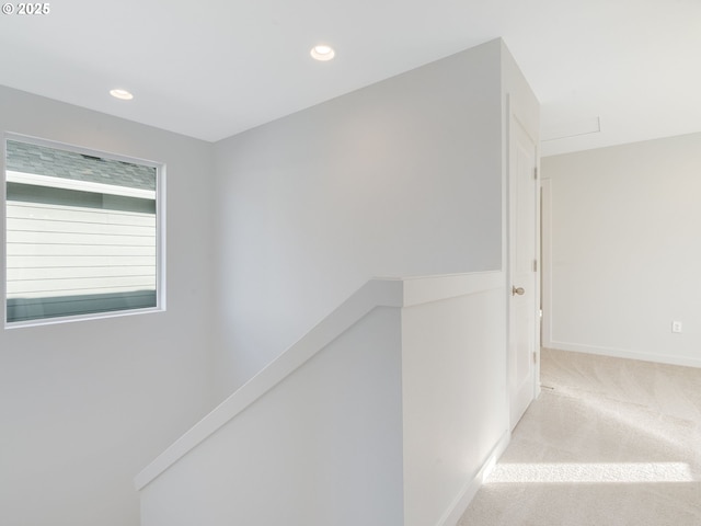 hallway featuring recessed lighting, carpet, baseboards, and an upstairs landing