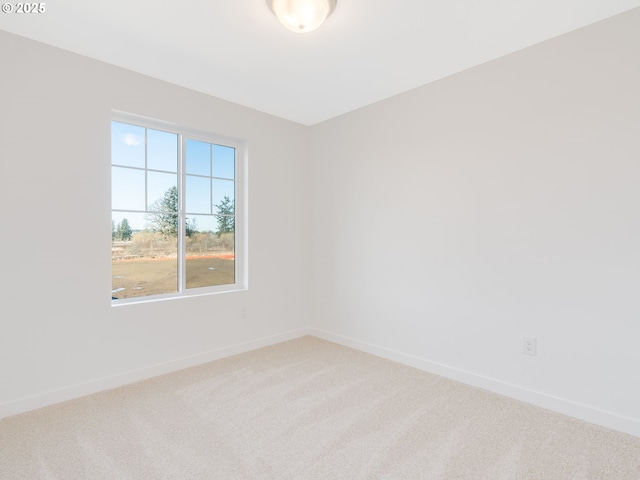 unfurnished room featuring carpet floors and baseboards