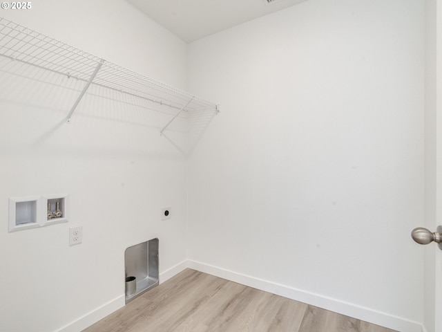 laundry area featuring washer hookup, light wood-style flooring, hookup for an electric dryer, laundry area, and baseboards