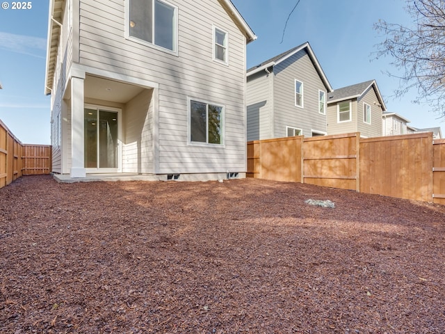 back of property featuring a fenced backyard