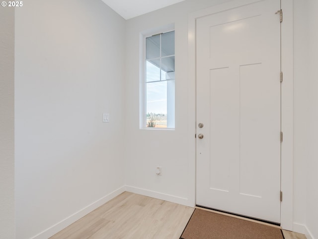 foyer with light wood finished floors and baseboards