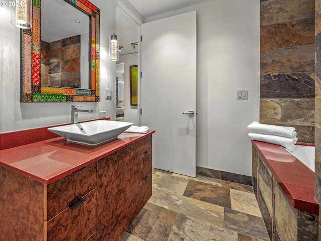 bathroom with vanity and stone tile flooring