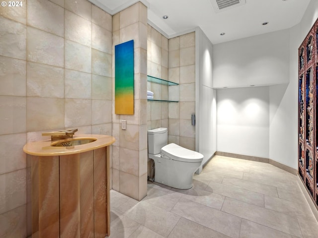 bathroom featuring tile walls, toilet, vanity, and tile patterned flooring