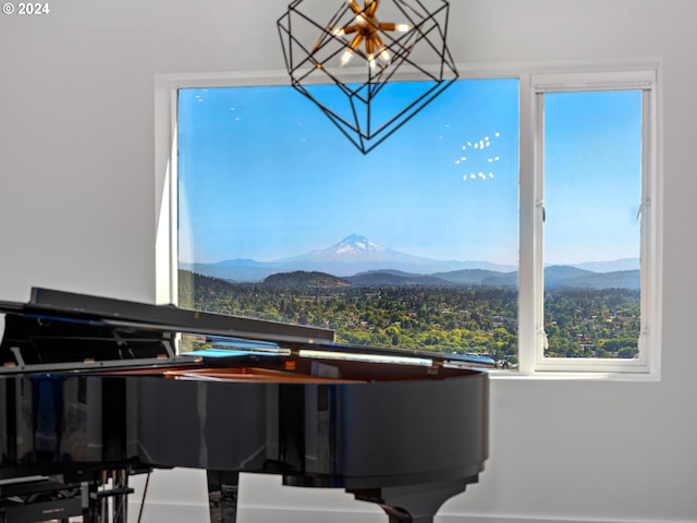 living area featuring a mountain view and an inviting chandelier