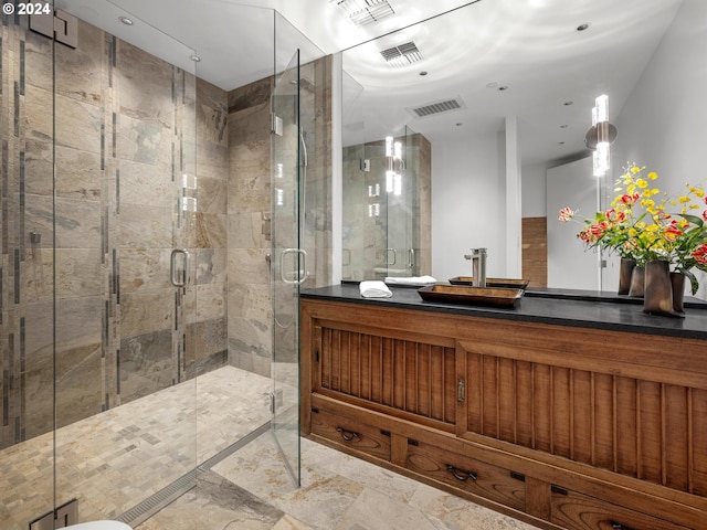 bathroom featuring vanity and a shower with shower door