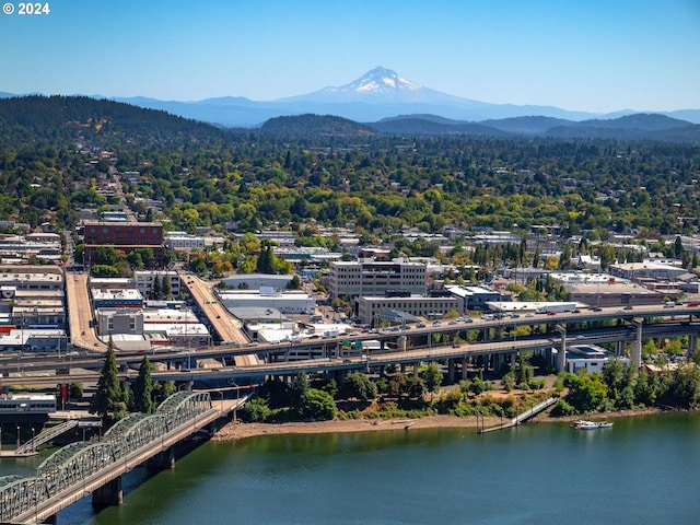 drone / aerial view with a water and mountain view