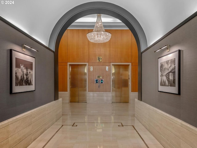 hallway with arched walkways and a notable chandelier