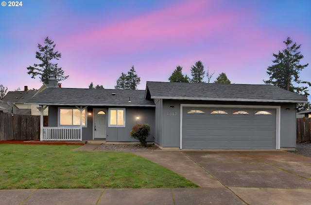 single story home with a yard and a garage