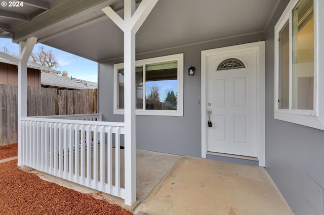 view of exterior entry featuring a porch