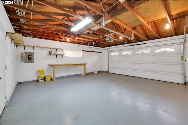 garage with a garage door opener and electric panel