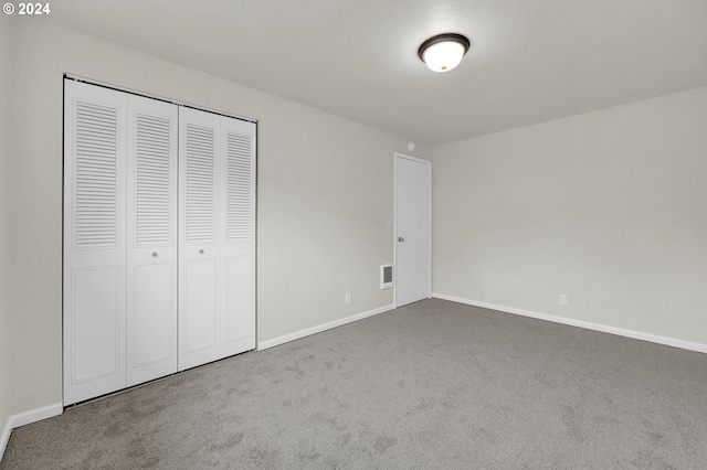 unfurnished bedroom with carpet flooring and a closet