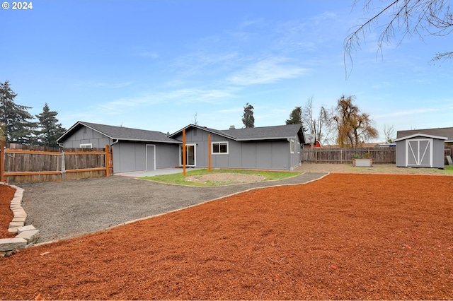 view of front of house with a storage shed