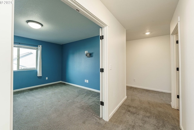 interior space featuring a textured ceiling and light carpet