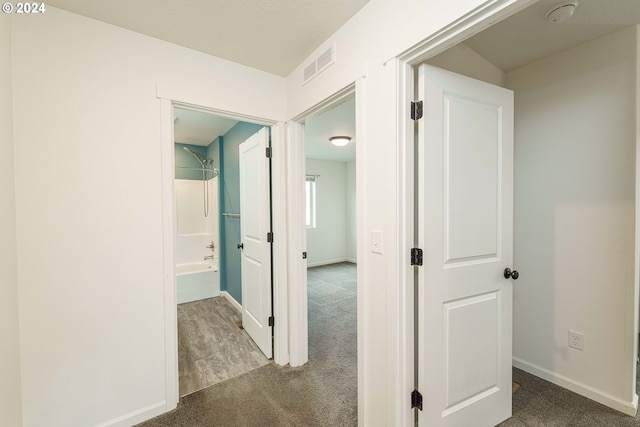 corridor with dark colored carpet