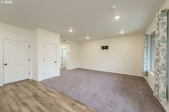 empty room with light hardwood / wood-style flooring