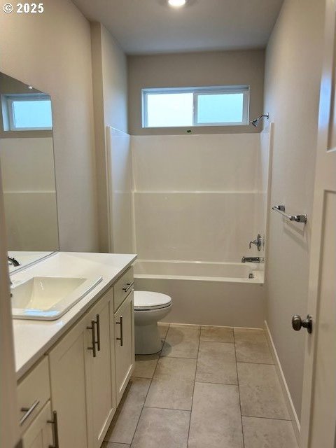 bathroom featuring shower / tub combination, tile patterned flooring, toilet, vanity, and baseboards