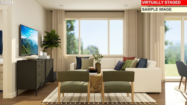 sitting room featuring plenty of natural light and hardwood / wood-style floors