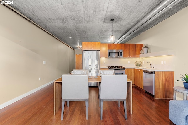 dining space featuring dark hardwood / wood-style floors and sink