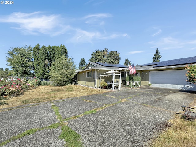 view of front of house featuring solar panels and a garage