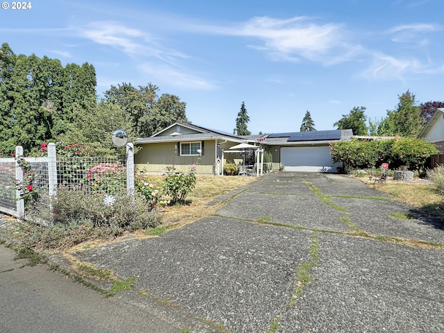 view of front of home with solar panels and a garage