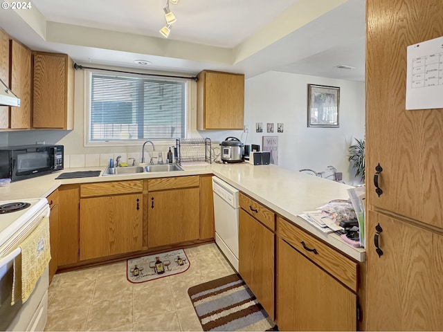 kitchen featuring kitchen peninsula, sink, white appliances, and light tile patterned flooring