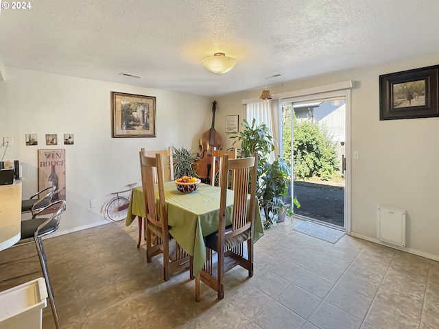 dining area with a textured ceiling