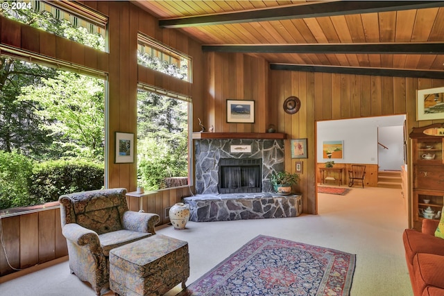 living room featuring wooden ceiling, light colored carpet, and wooden walls