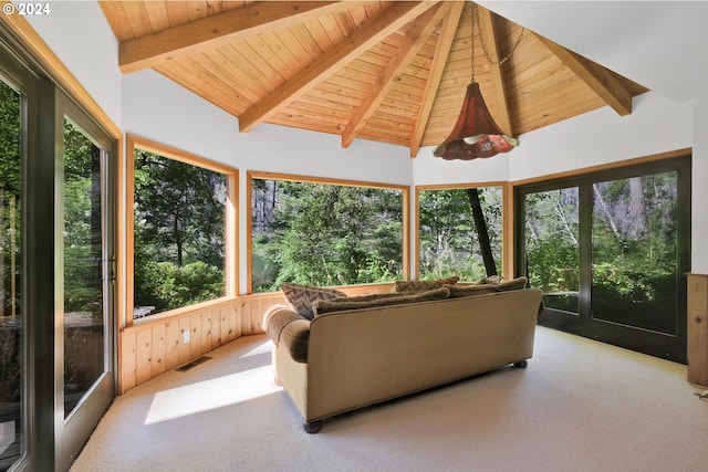 sunroom with lofted ceiling with beams, plenty of natural light, and wood ceiling