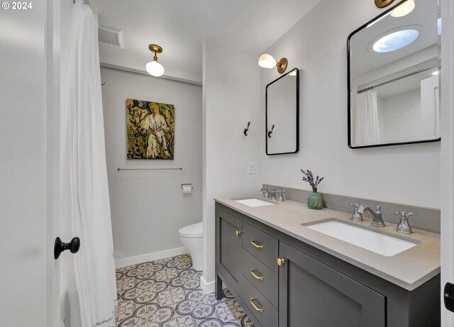 49356 Mckenzie Hwy, Vida, OR 97488 - full bathroom featuring toilet, baseboards, double vanity, and tile patterned flooring