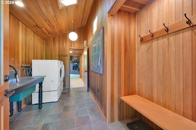 49356 Mckenzie Hwy, Vida, OR 97488 - laundry area with wood walls, washer / dryer, dark stone finish flooring, and wooden ceiling