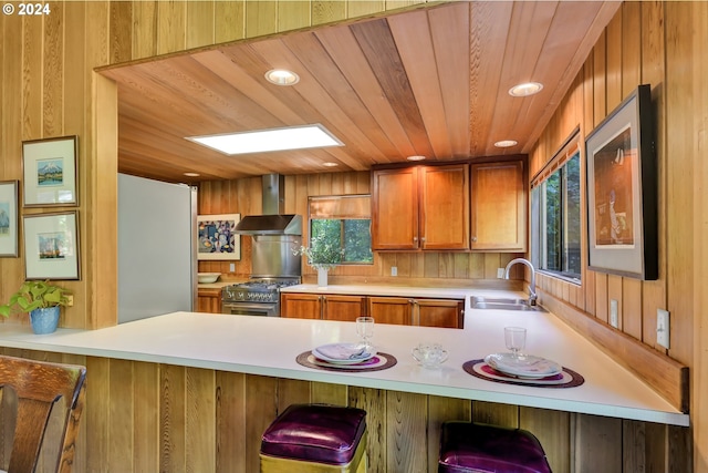 49356 Mckenzie Hwy, Vida, OR 97488 - kitchen with wall chimney range hood, a sink, a peninsula, stainless steel range, and recessed lighting