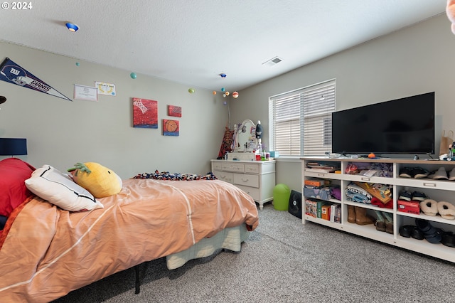 carpeted bedroom with a textured ceiling