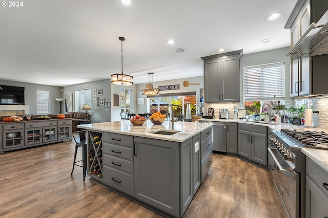 kitchen with gray cabinetry, sink, a kitchen island, and stainless steel appliances