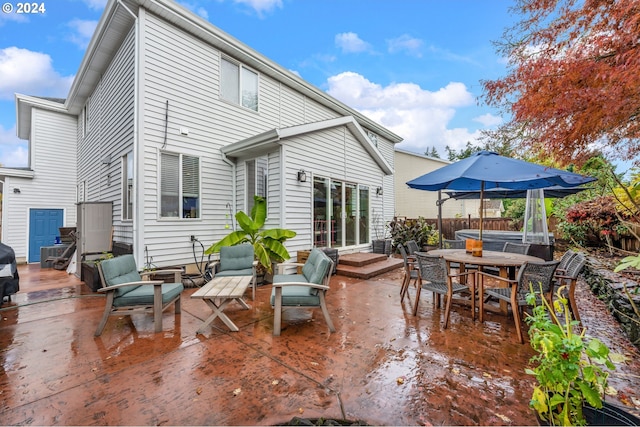 back of property with a patio