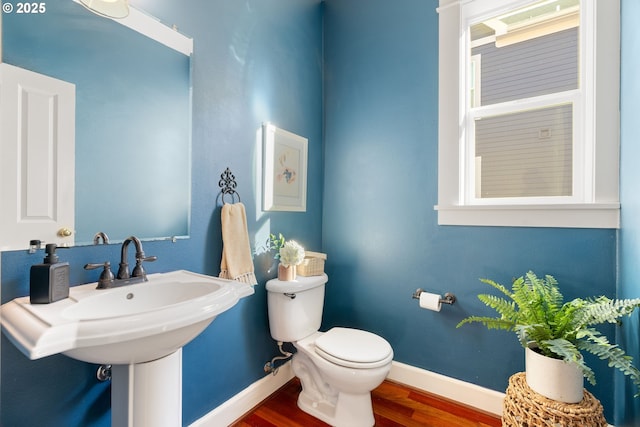 bathroom featuring hardwood / wood-style flooring and toilet