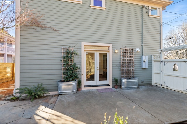 view of exterior entry featuring a patio and french doors