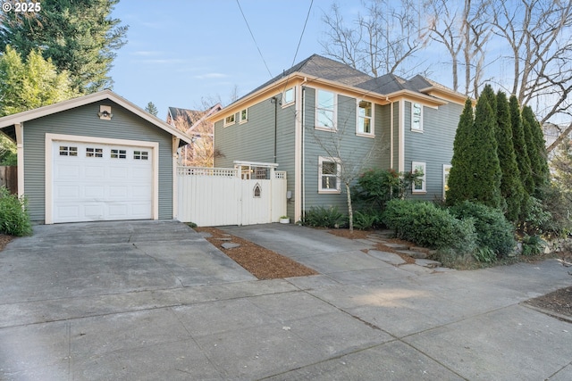 view of side of home with a garage and an outbuilding