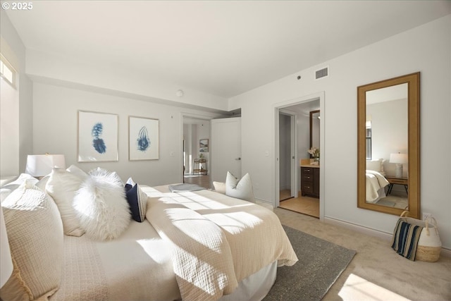 bedroom featuring connected bathroom, visible vents, and light colored carpet