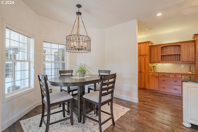 dining space featuring a healthy amount of sunlight, baseboards, and dark wood finished floors