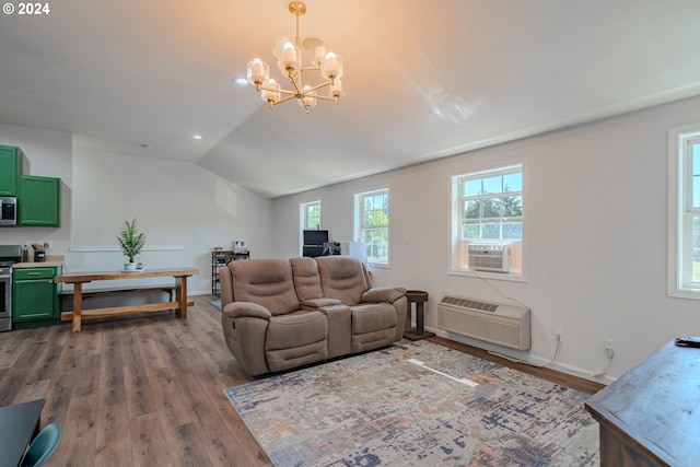 living area with lofted ceiling, an AC wall unit, cooling unit, and wood finished floors