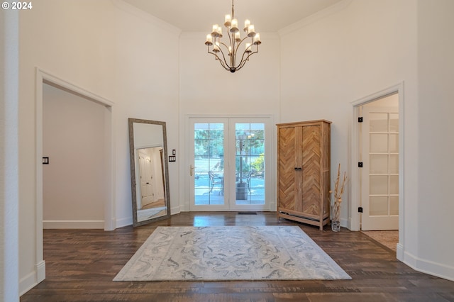 entrance foyer with baseboards, dark wood finished floors, and crown molding