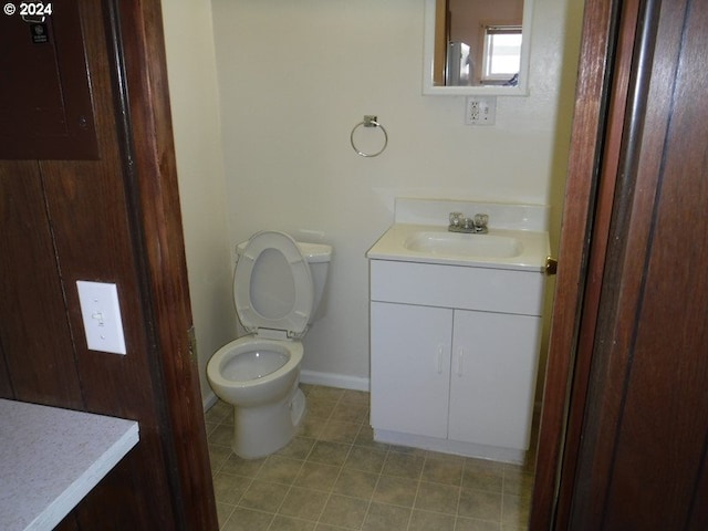 160 Spring St, Gardiner, OR 97441 - bathroom featuring toilet, baseboards, tile patterned flooring, and vanity