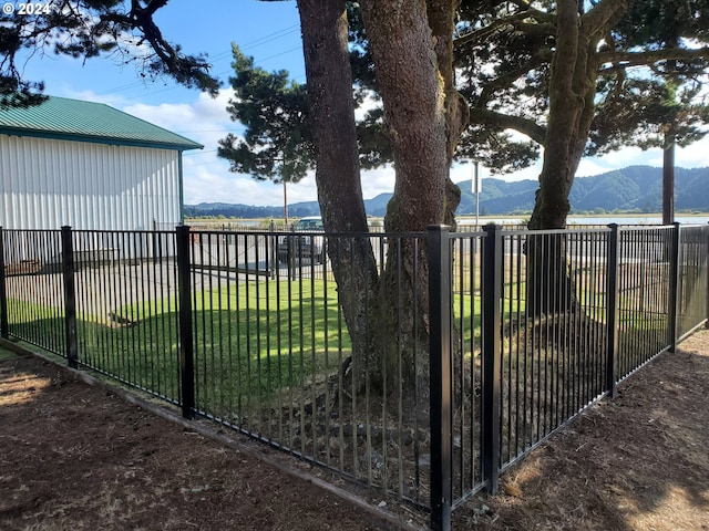 160 Spring St, Gardiner, OR 97441 - view of gate featuring a mountain view, a yard, and fence